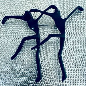 Beautiful black dance pin that expresses graceful movement